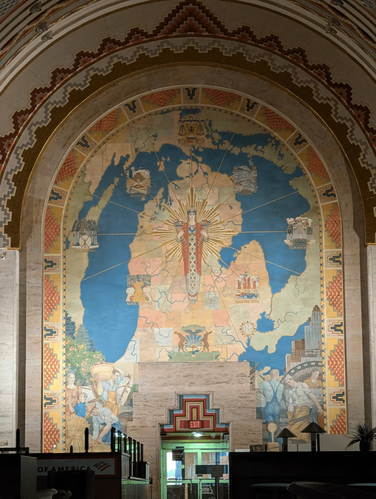 The Spirit of Detroit map mural showing Michigan flanked by Mining, Fishing, Lumbering, Agriculture, Manufacture, Commerce, and Finance