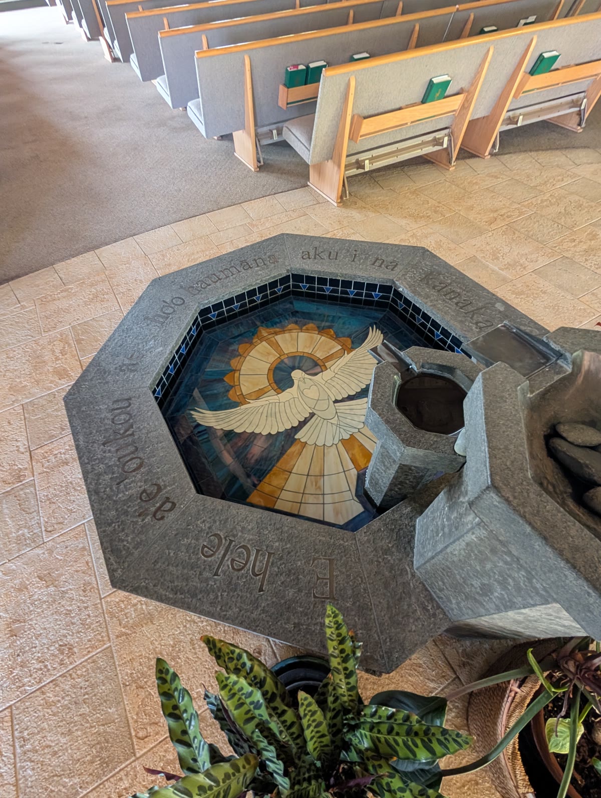 Baptismal font with the Holy Spirit dove, inscribed in Hawaiian